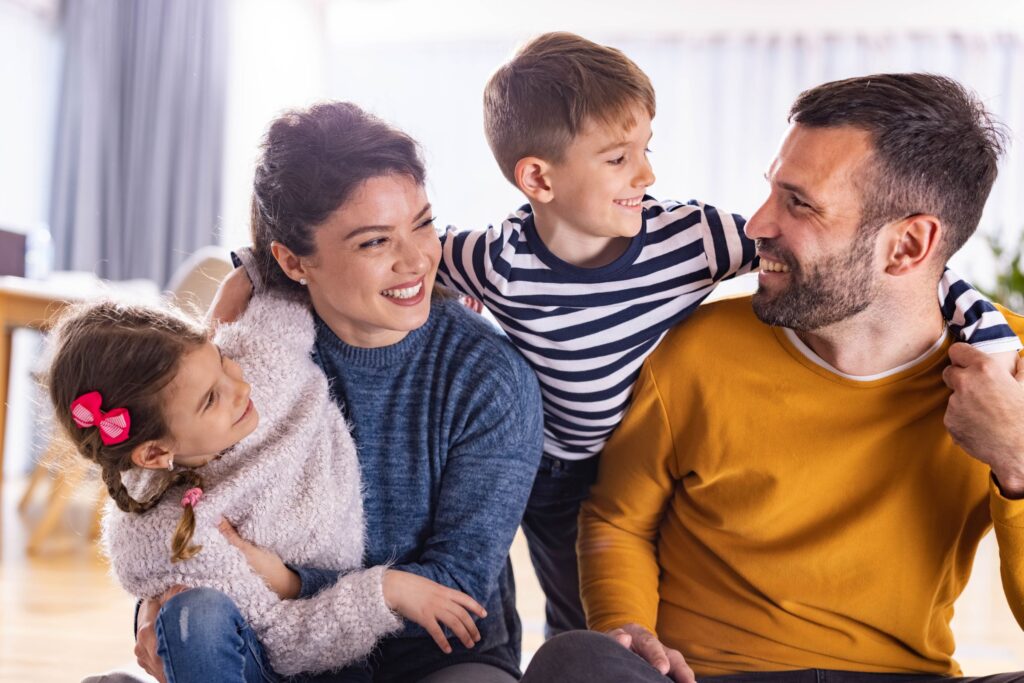 Happy parents communicating with their small kids.