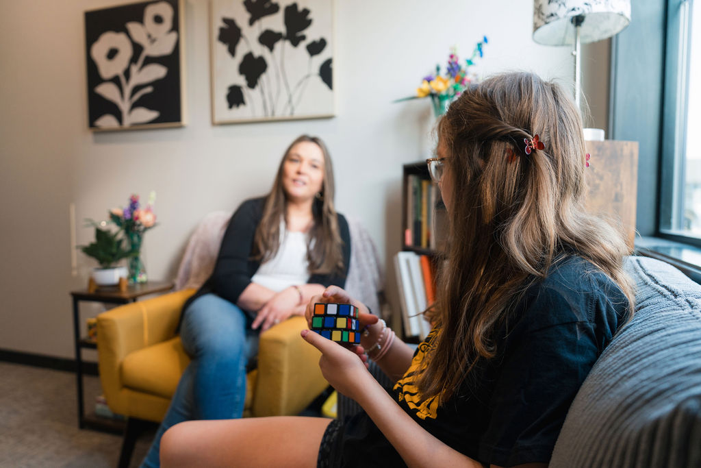 Photo of Alissa DeCoteau blurred in the background, with a client in the foreground