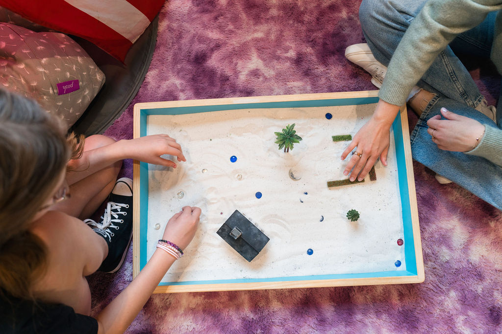 Overhead view of two people using a sandbox
